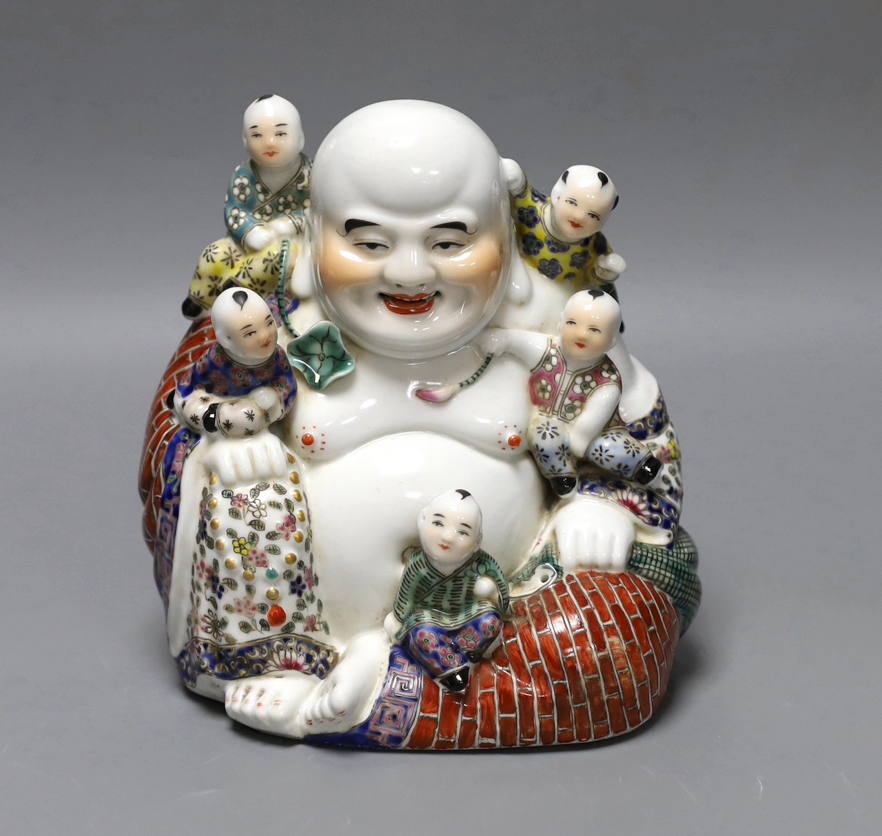A Chinese Budai and boys group, 19 cms high.